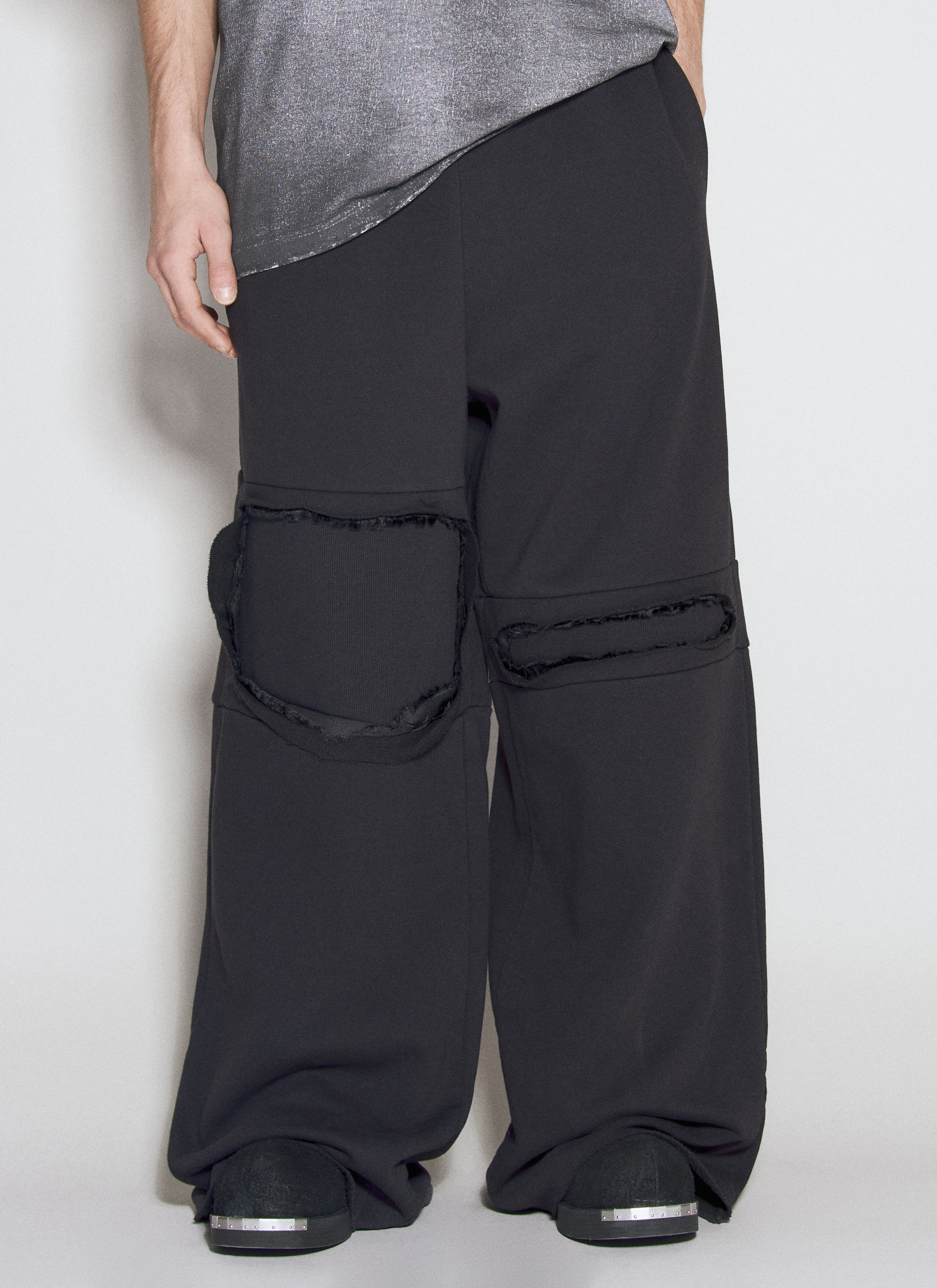 Distressed track pants discount