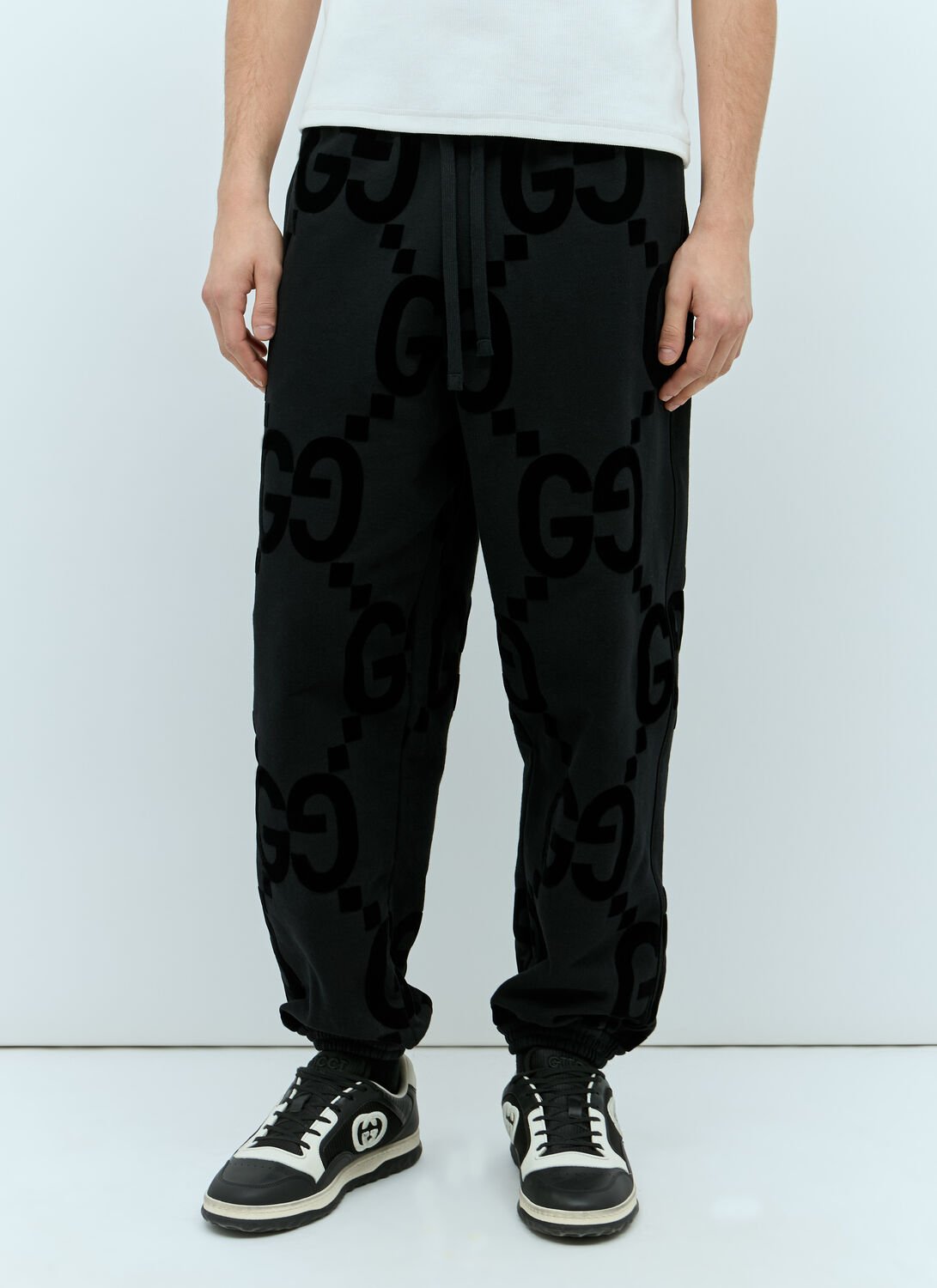 Shop Gucci Gg Flocked Print Cotton-fleece Track Pants In Black