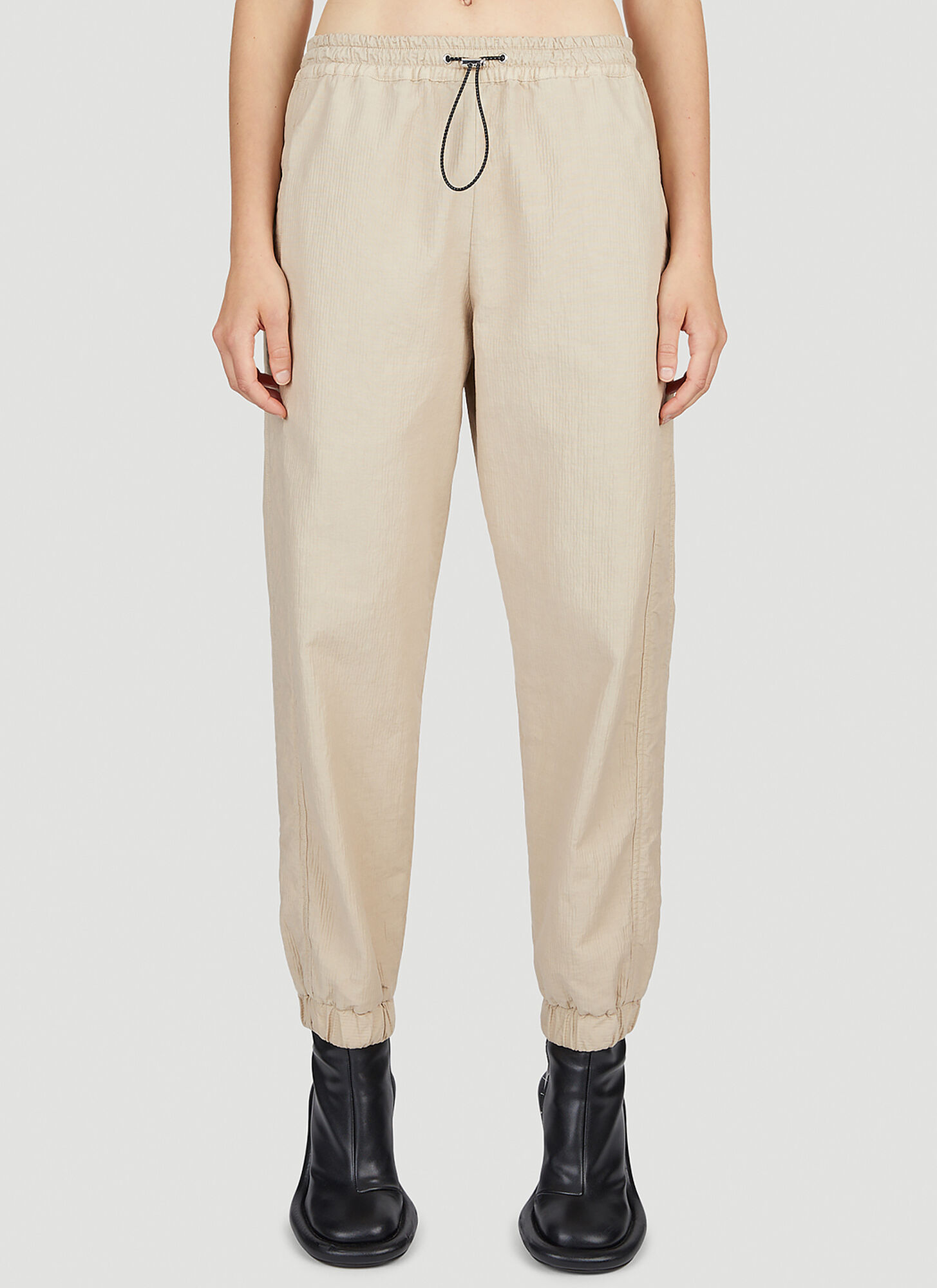Shop Jw Anderson Tapered Track Pants In Beige