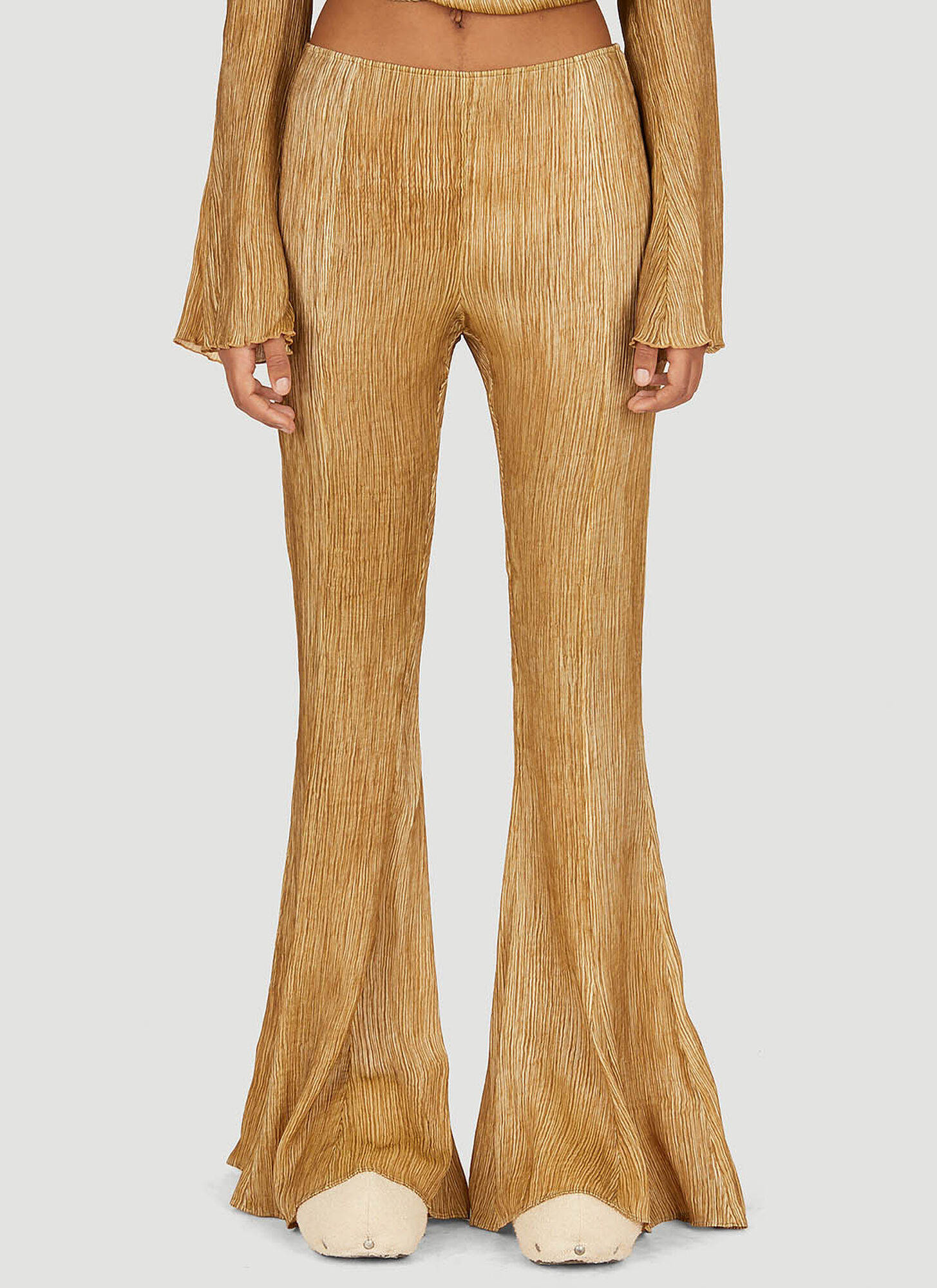 Shop Acne Studios Flared Plisse Pants In Gold