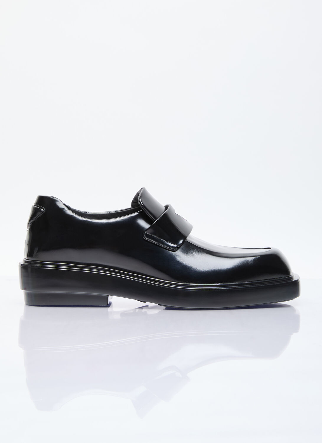 Prada Triangle Patch Leather Loafers In Black